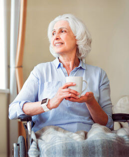old woman holding a cup of coffee
